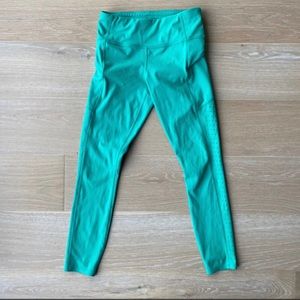 Athleta Contender 7/8 laser cut green tights leggings in XS.